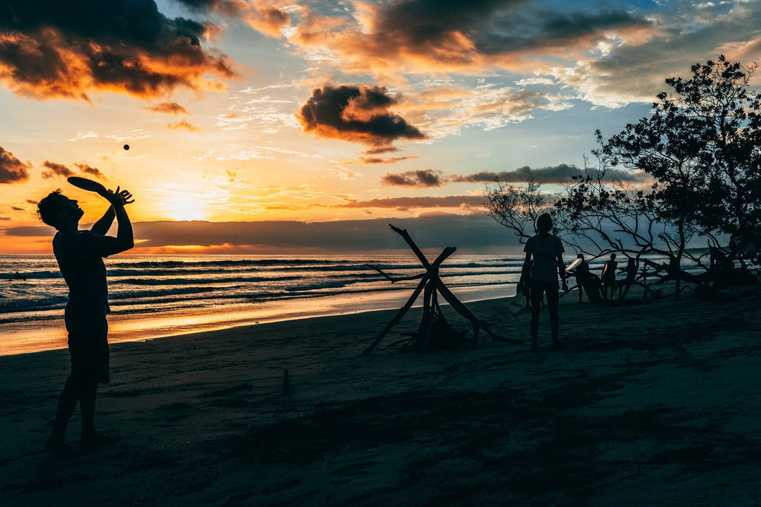 Travelers celebrating at sunset after completing a trusted adventure experience curated by Outer
