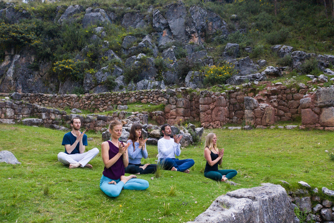 Group of travelers having a yoga session in the Andes mountains in Peru